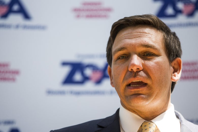 Florida Rep. Ron DeSantis speaking in front of a banner for the Zionist Organization of America.